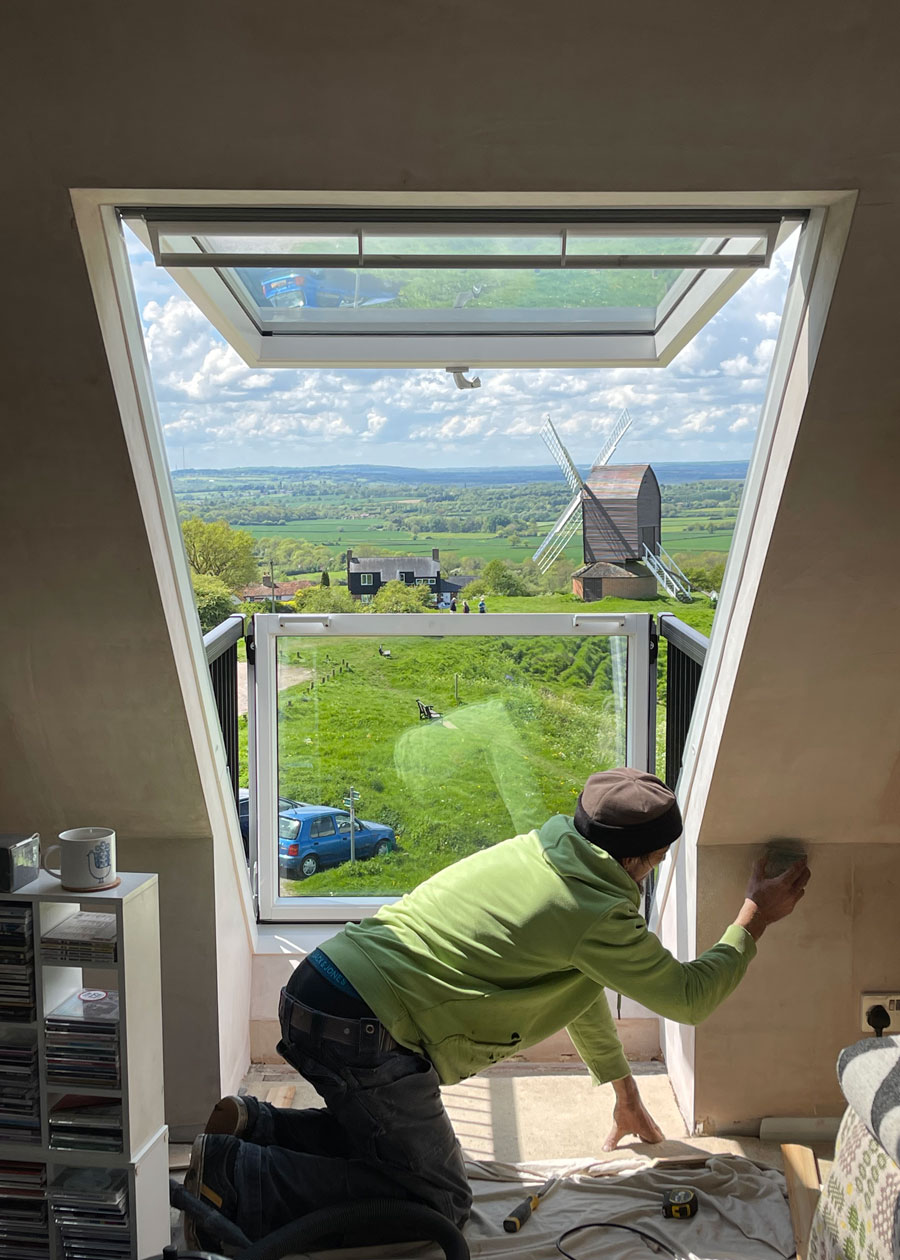 A VELUX window installation in progress with a beautiful view